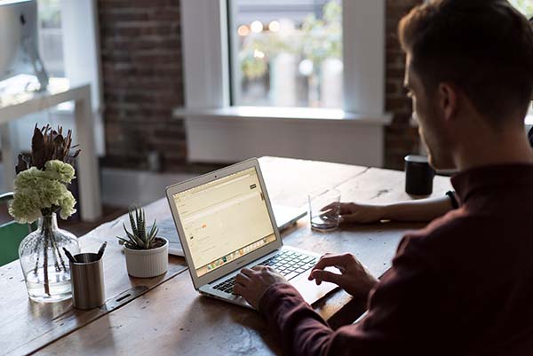 Man at kitchen table working on website