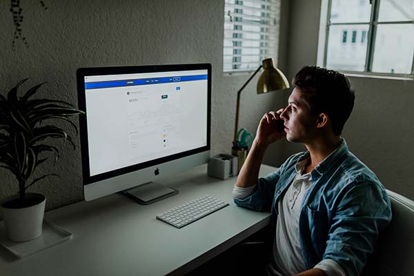 Serious looking man with an iMac